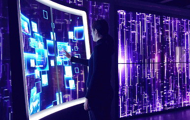 A person standing in front of a large computer.