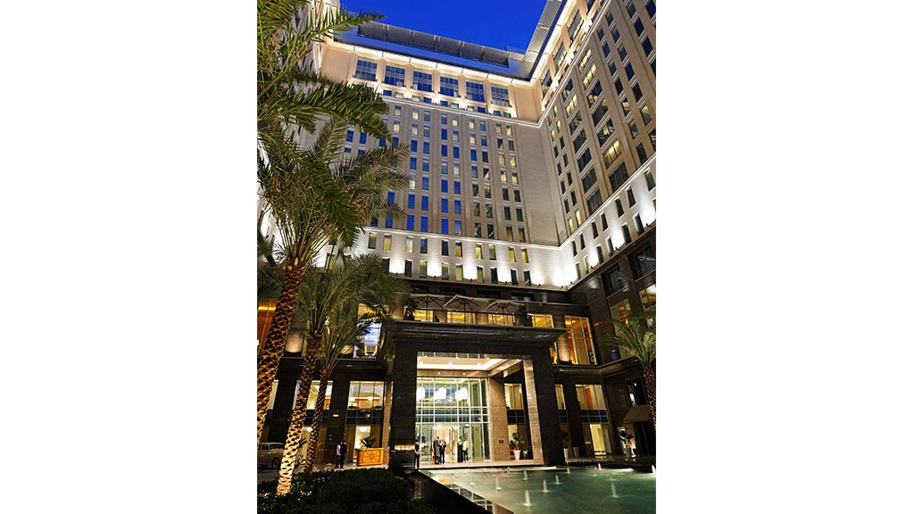 A building with a pool in front.