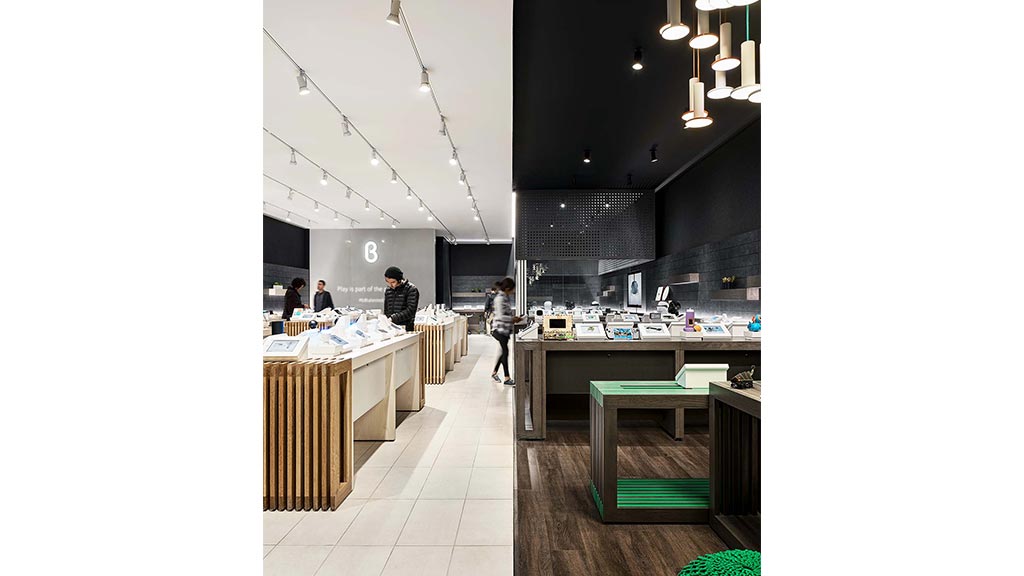 A group of people in a room with tables and chairs.