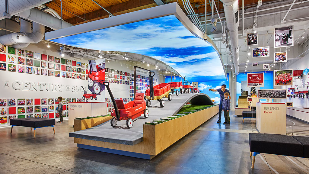 A person standing on a platform with a model airplane on it.