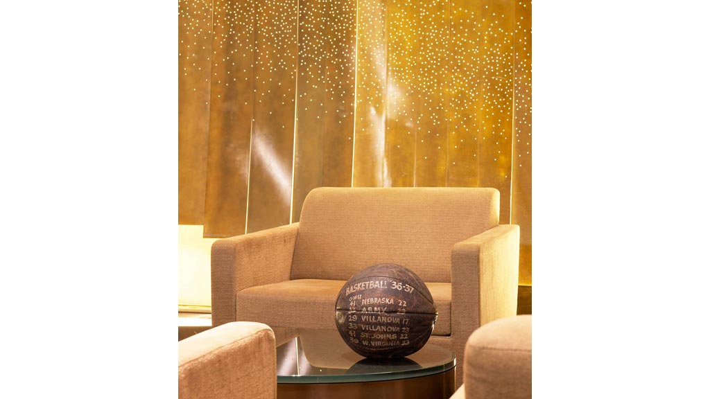 A couch with a round object on it.