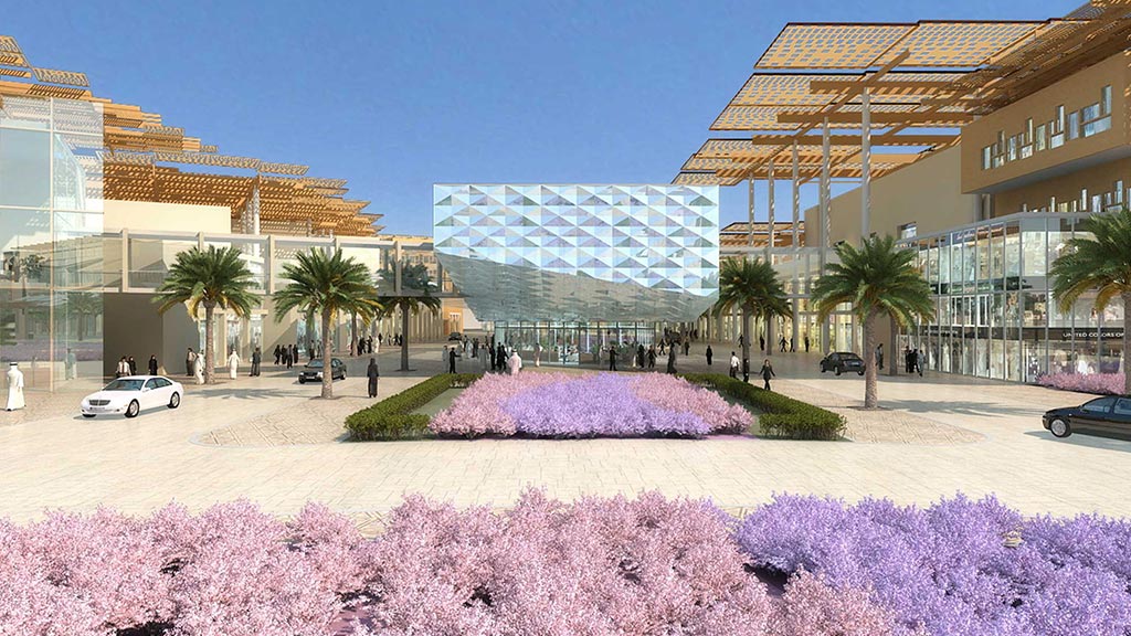 A courtyard with flowers and trees in front of a building.