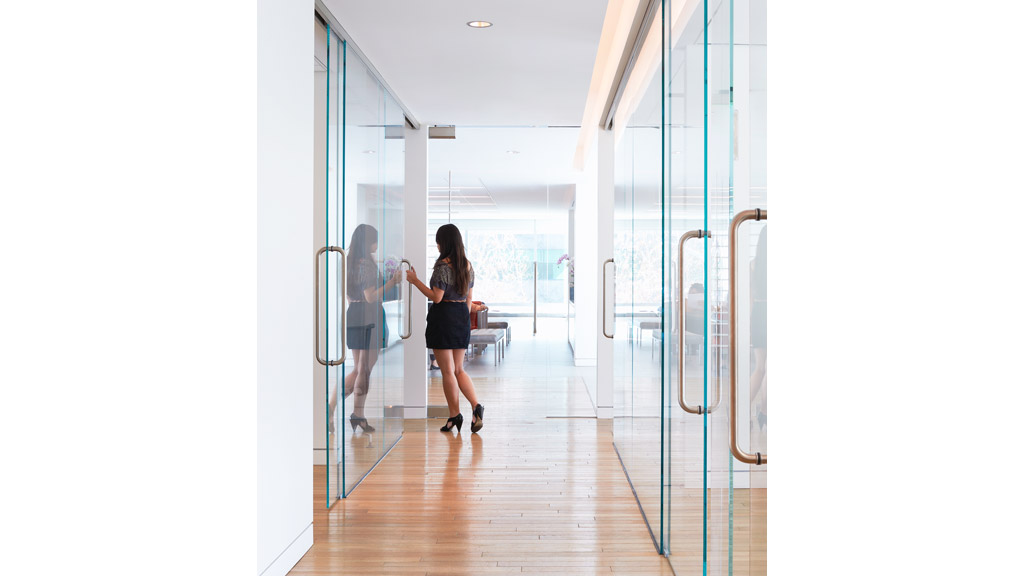 A woman walking in a hallway.
