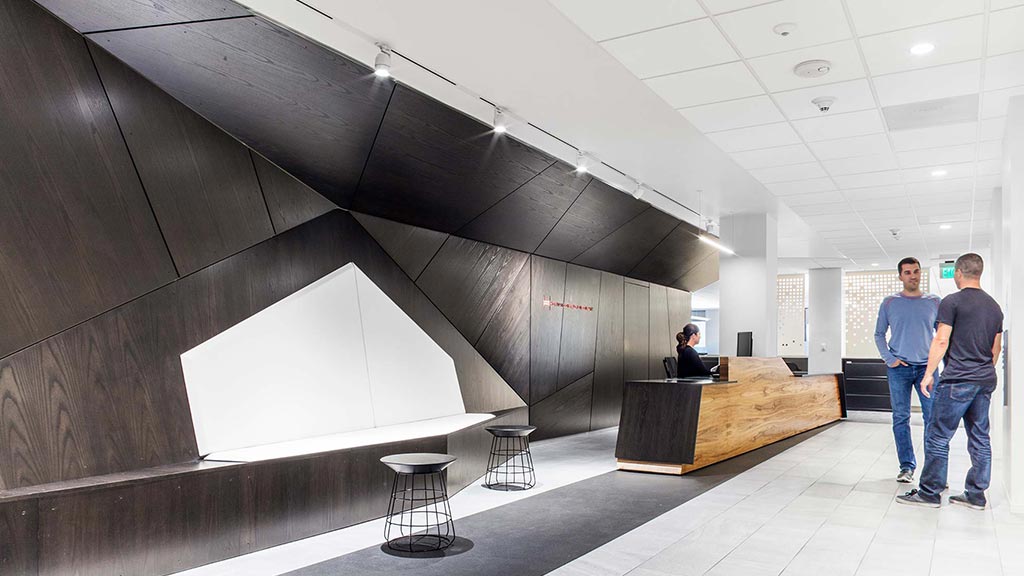 A couple of men standing next to a large white rectangular object.