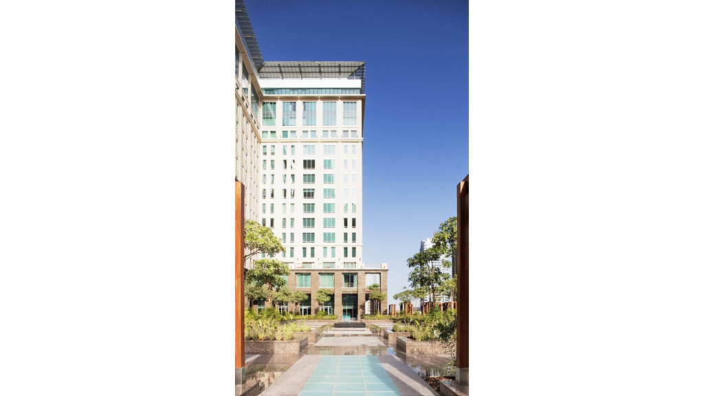 A building with a pool in front.