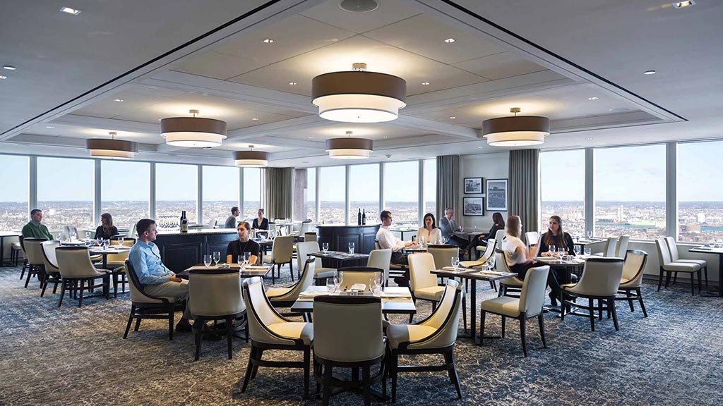 A group of people sitting at tables.