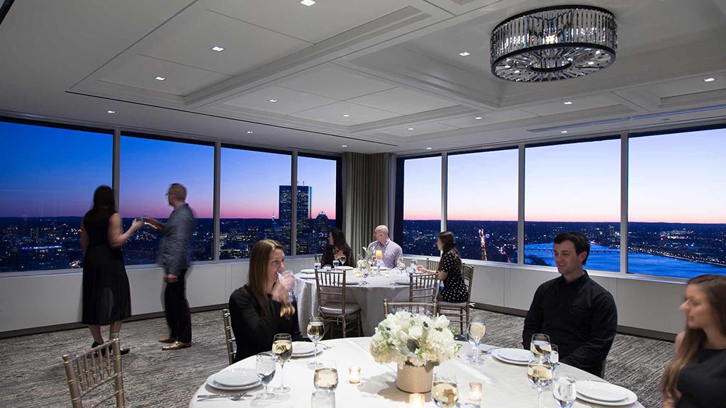 A group of people sitting at tables.