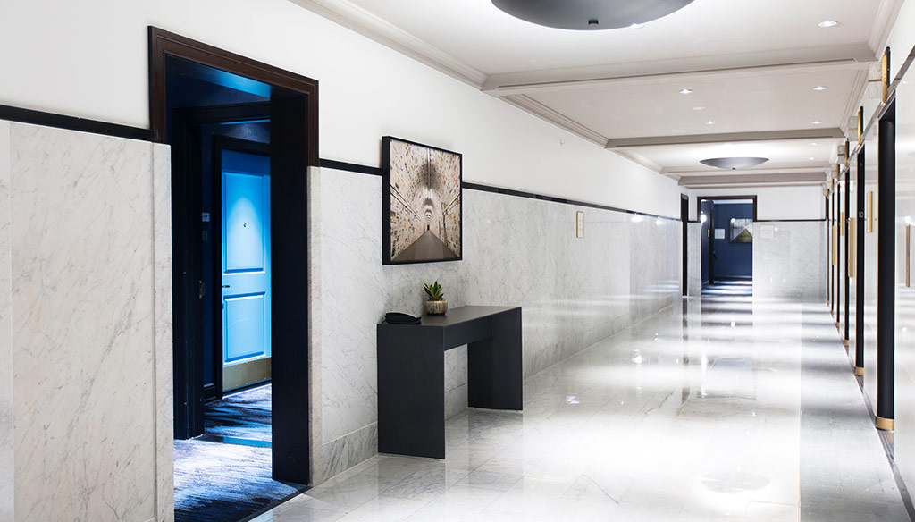 A hallway with a table and a door.