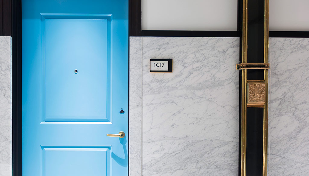 A blue door with a gold handle.