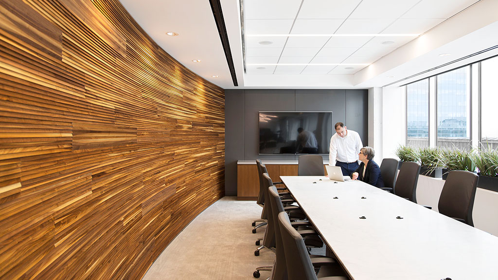 A man and woman in a conference room.