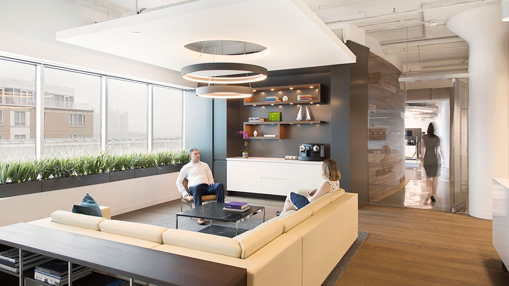 A man and woman sitting at a table in a large room.