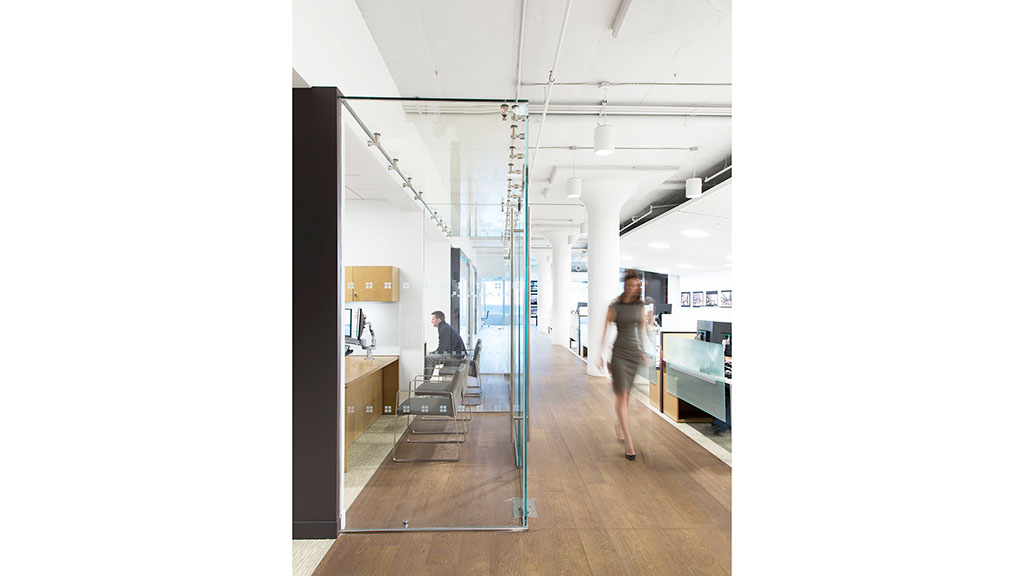 A man walking in a hallway.