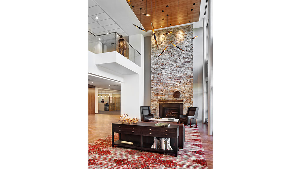 A room with a fireplace and a table with a tv on it.