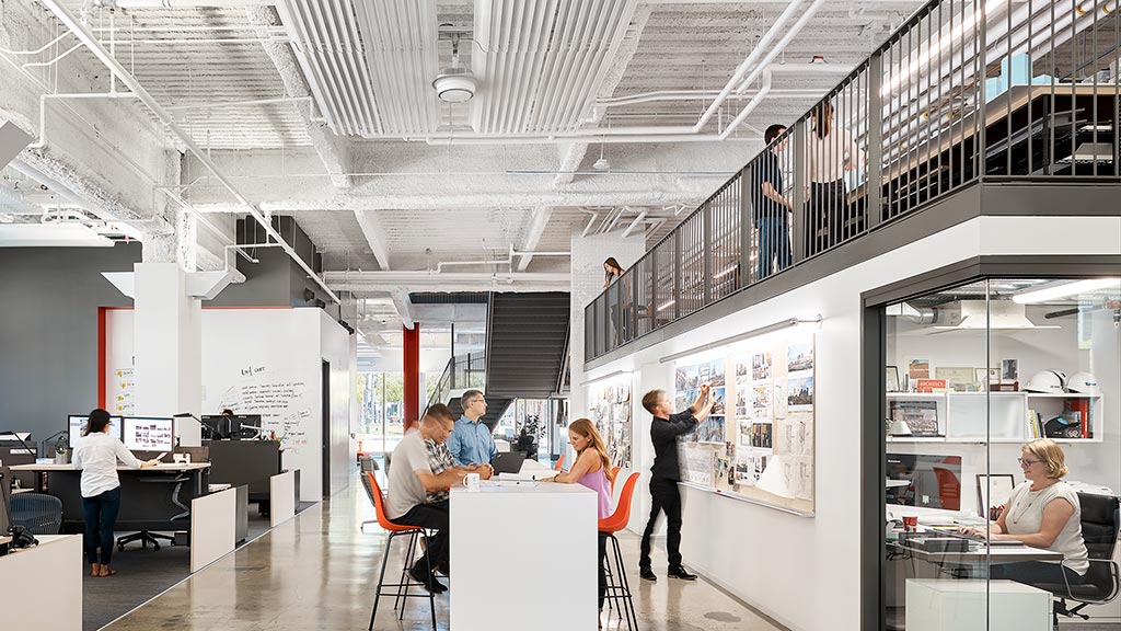 People in a room with tables and chairs.