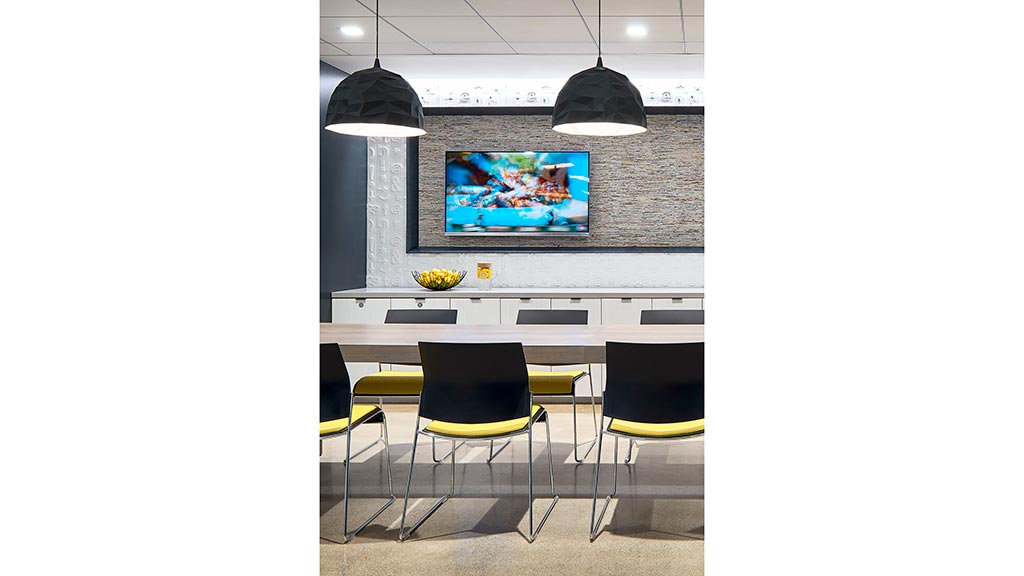 A room with chairs and a tv.