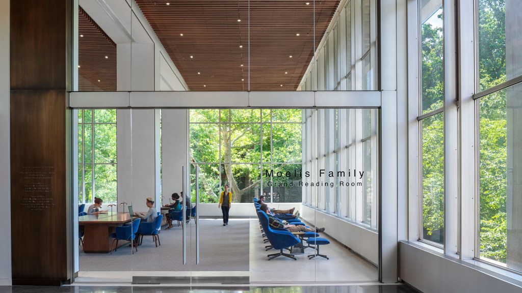 A room with windows and people sitting at tables.