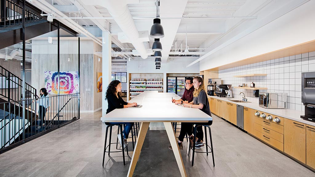 A couple of women sitting at a table in a restaurant.