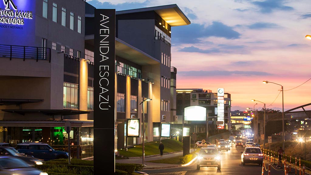 A street with cars and buildings on either side of it.