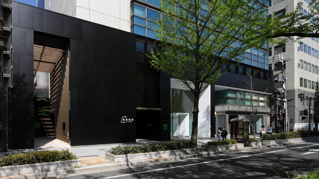 A building with a tree in front.