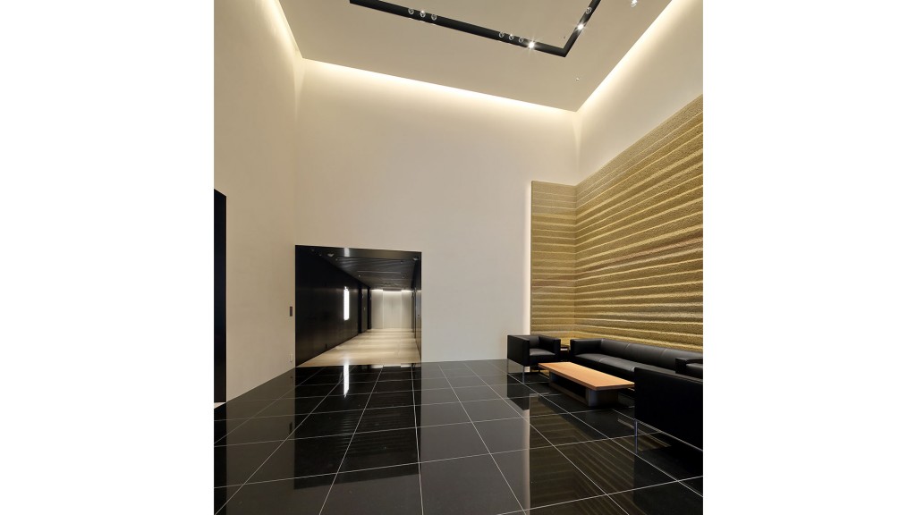 A room with black couches and a black floor.