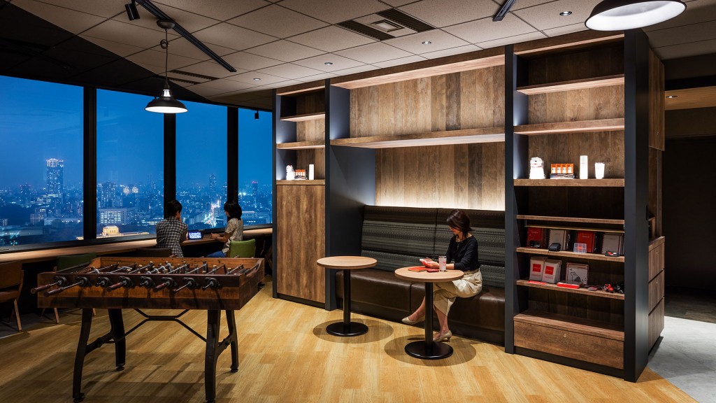 A person sitting at a table in a library.
