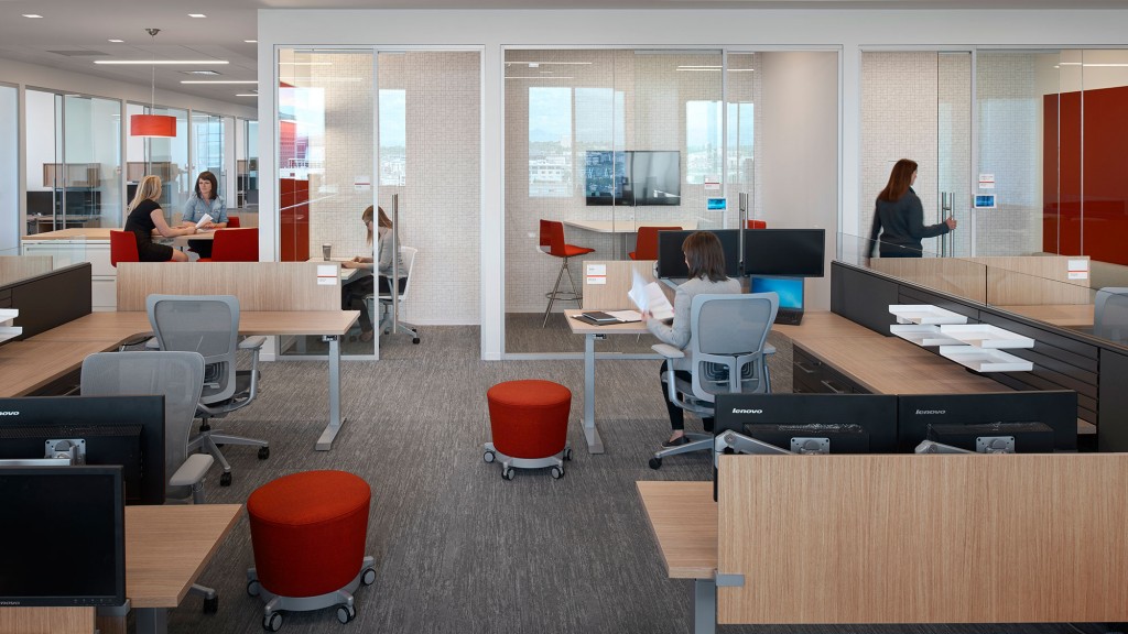 A room with a table chairs and a person in the background.