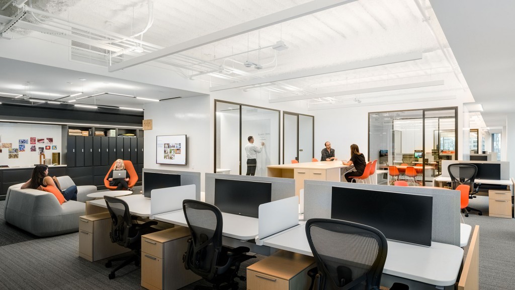 A room with a few people and computers.