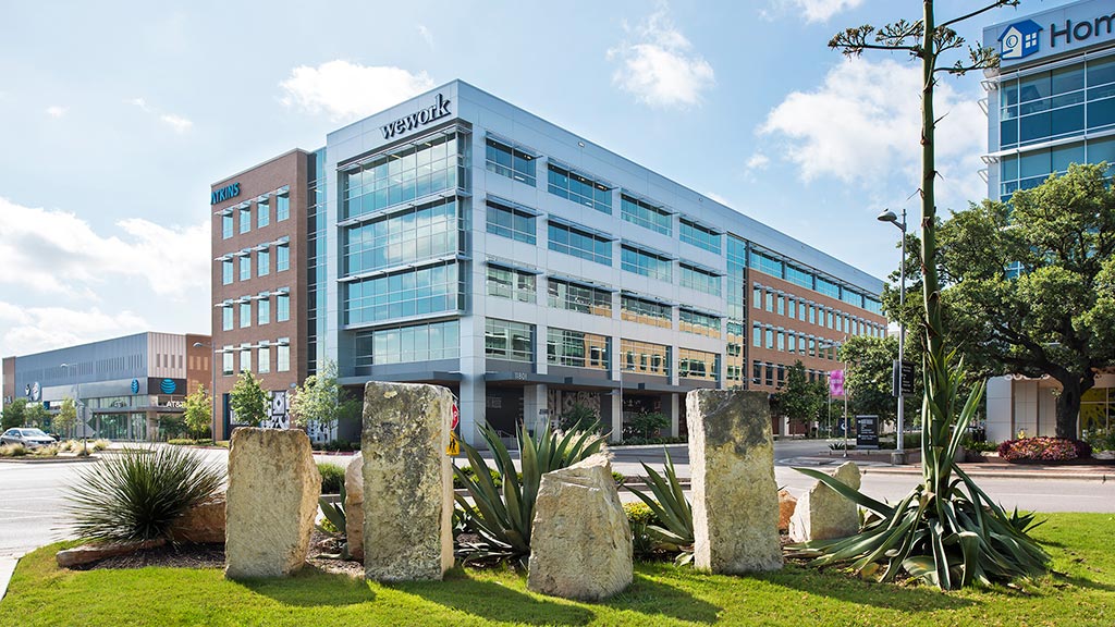 A building with a green lawn.