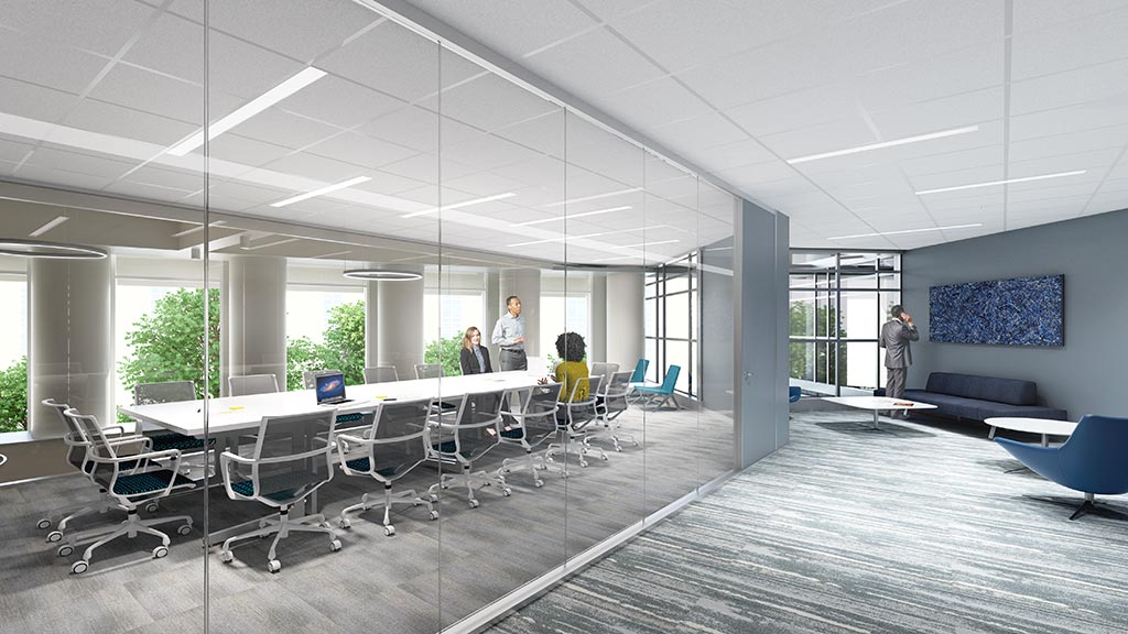 A group of people in a room with chairs and tables.