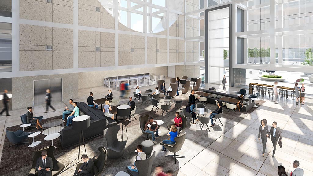 A group of people in a large room with windows and a large group of people sitting at tables.