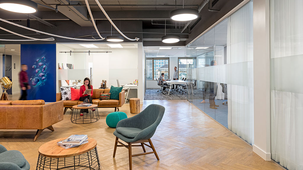 A room with a few people and a table and chairs.