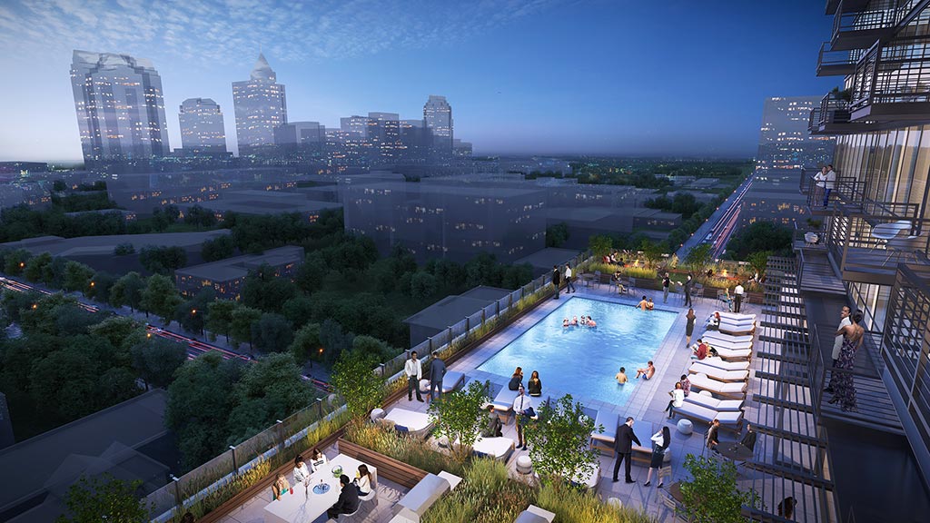 A pool surrounded by buildings and trees.