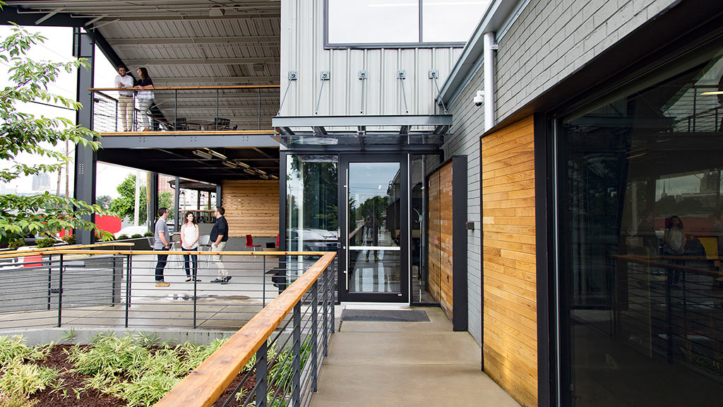 A group of people walking outside a building.