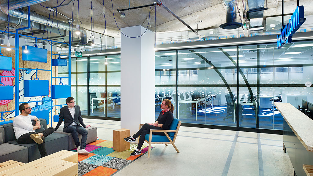 Men sitting in chairs in a room.