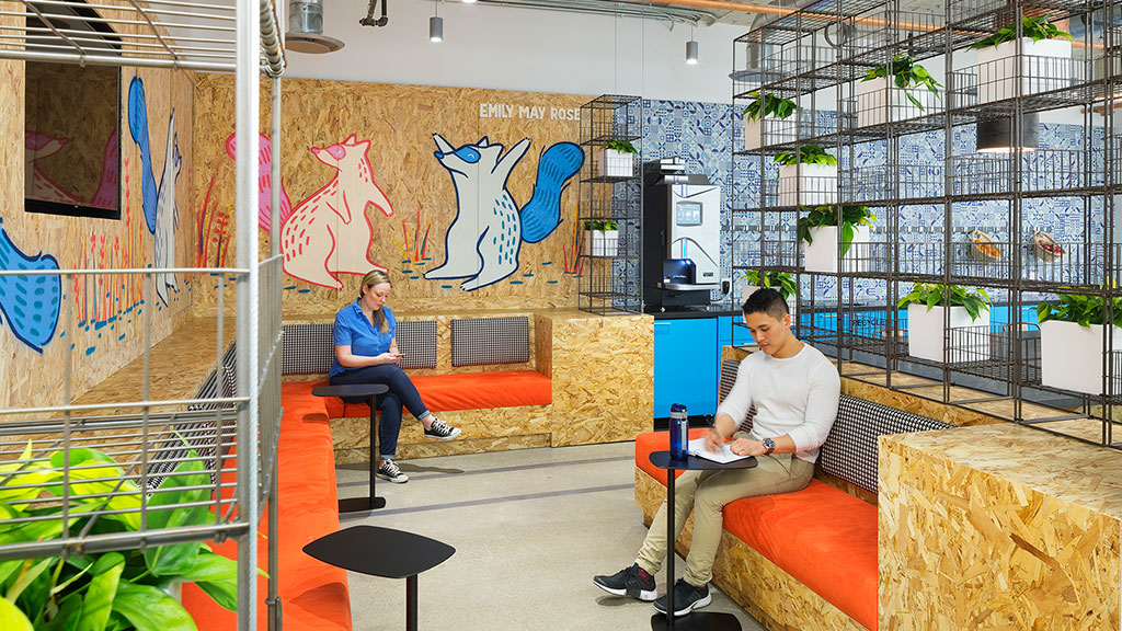 A couple of people sit on a couch in a room.