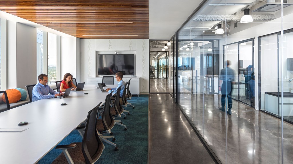A group of people sitting at a table in an office.