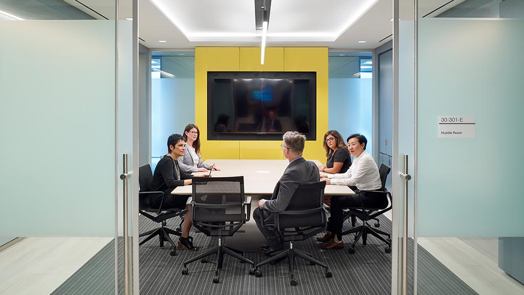 A group of people sitting around a table.