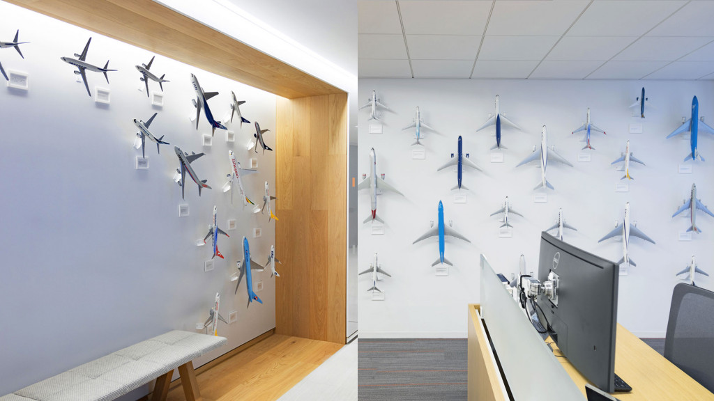 A room with a wall of airplanes.