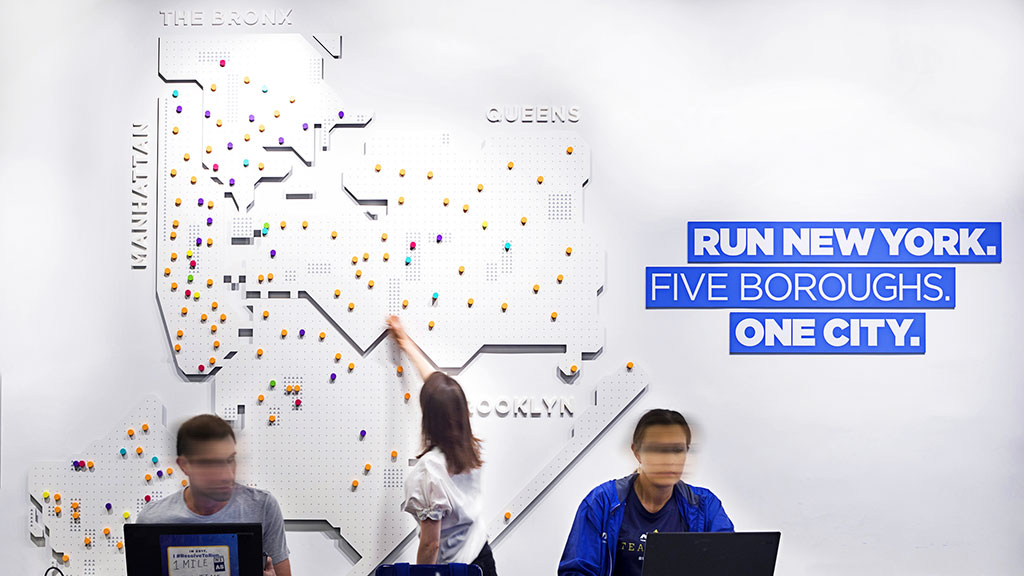 A group of people looking at a white board with a map.