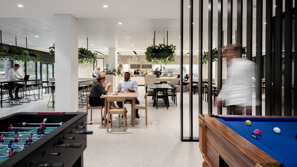 People sitting at tables in a room.