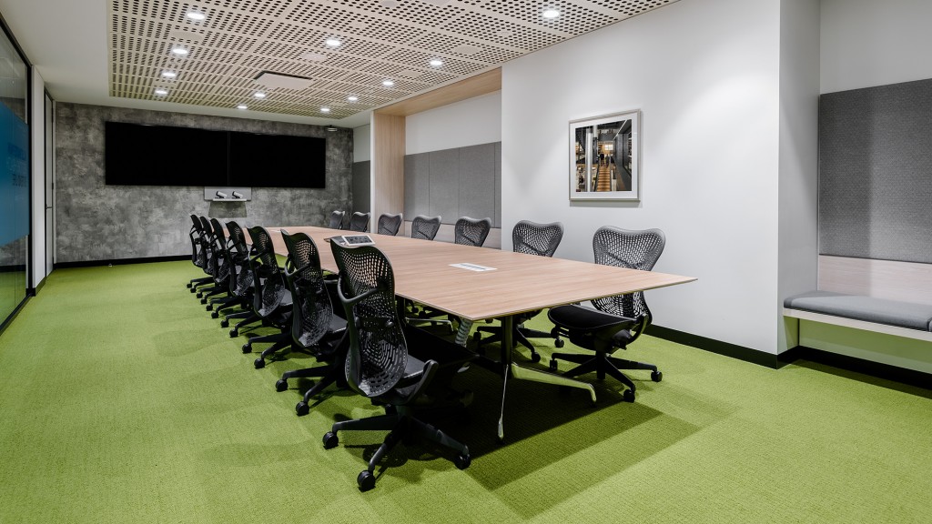 A conference room with a large table and chairs.