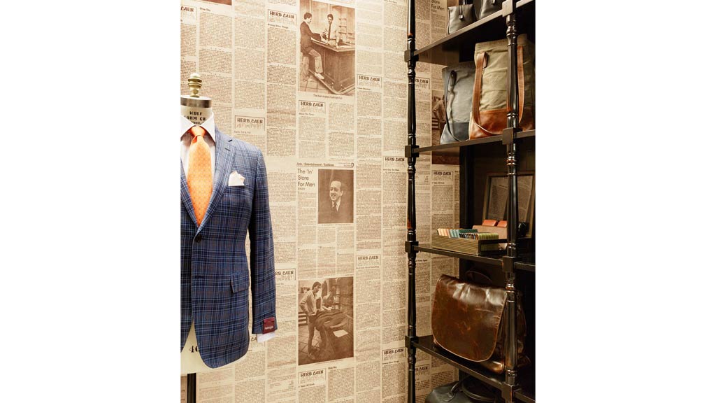 A wall with a poster and a chair.