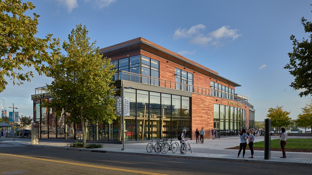 A building with a street and people walking by it.