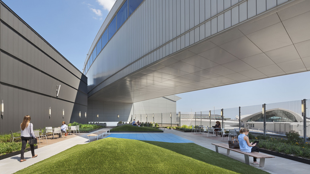 A building with a pool and people.