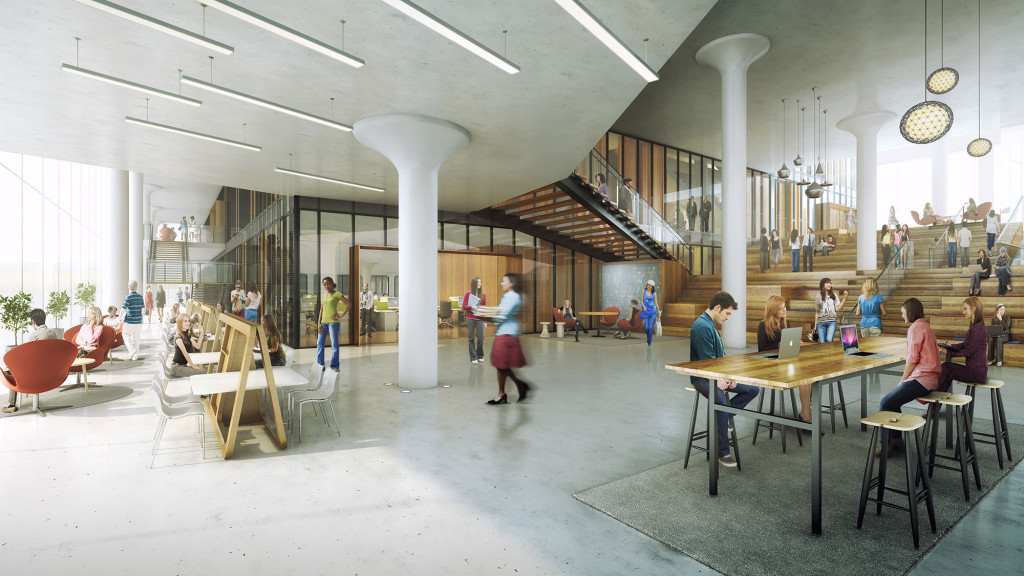A group of people in a large room with tables and chairs.