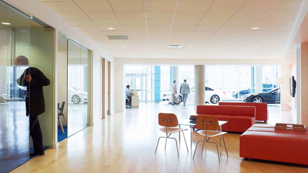 A person taking a picture of a car showroom.