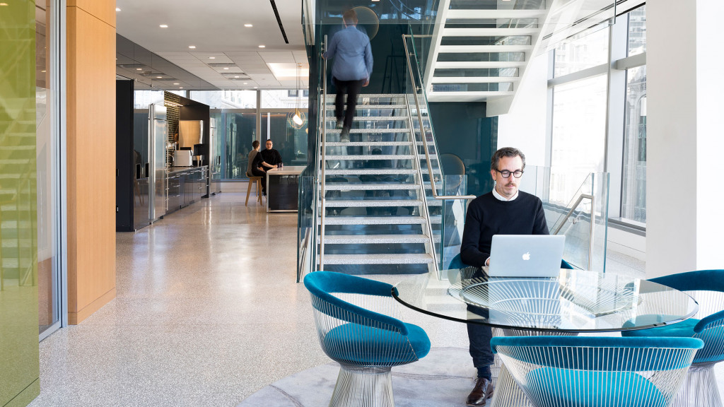 A person sitting at a table with a laptop.
