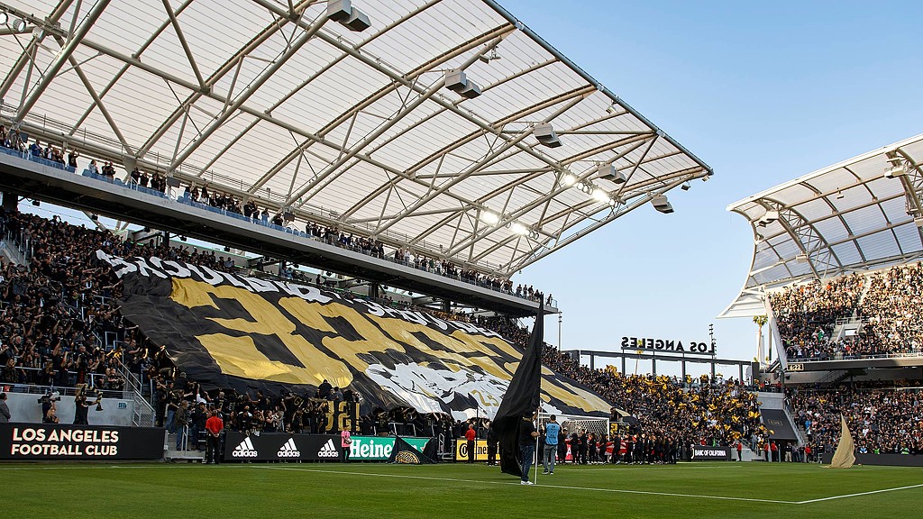 A stadium with a field and a crowd of people.