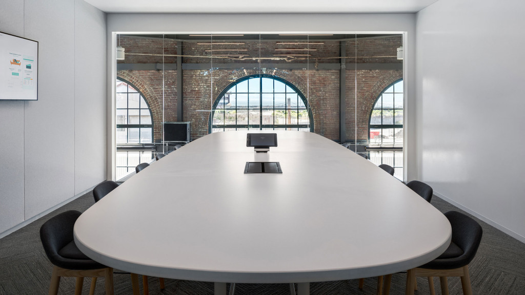 A round white table with chairs around it.