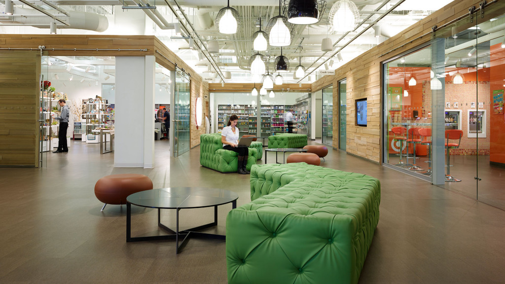 A room with a couch and chairs.